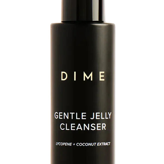 Black bottle of DIME Gentle Jelly Cleanser on a beige background